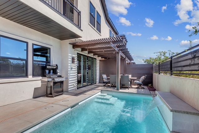 Private pool with pergola dining and grill beside the house