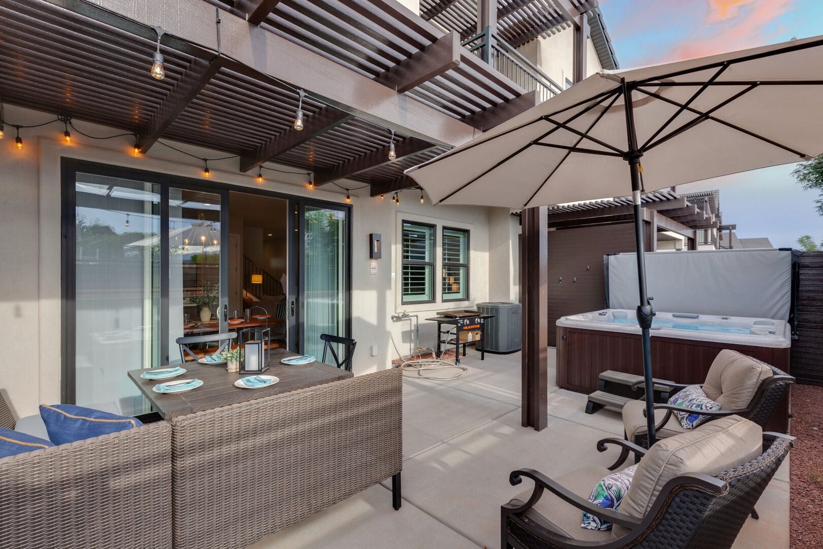 Covered patio with lounge seating and private hot tub at Ocotillo Springs 44~Sky Fire