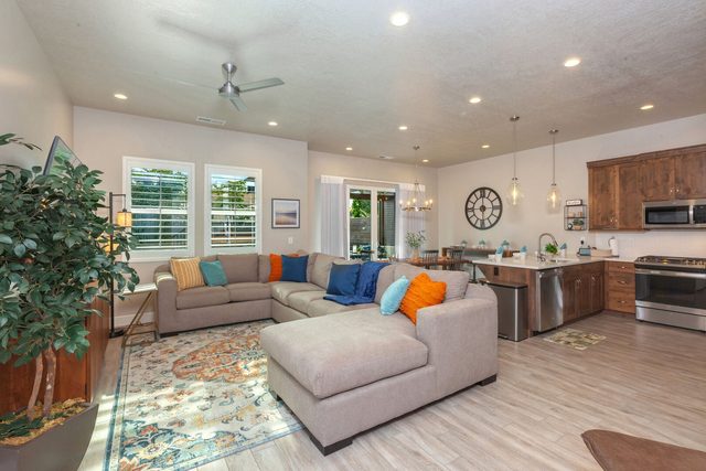 Open living room with large sectional and kitchen beyond at Ocotillo Springs 44~Sky Fire
