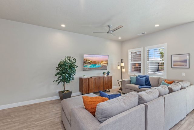 Sectional sofa facing wall-mounted TV in living room at Ocotillo Springs 44~Sky Fire