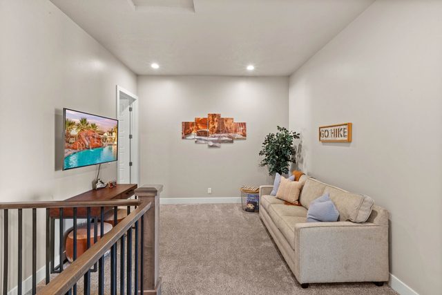 Upstairs loft with sofa and wall-mounted TV at Ocotillo Springs 44~Sky Fire