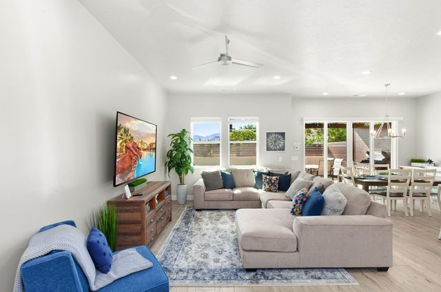 Living room with sectional sofa, large TV and dining area