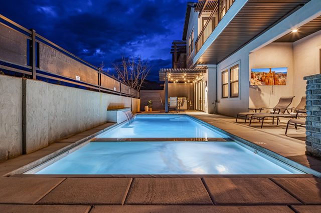 Private pool and spa with outdoor TV at night
