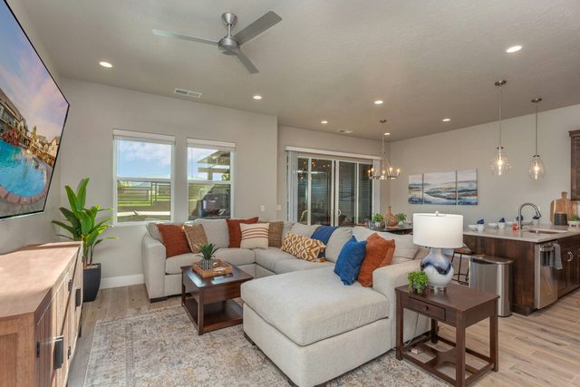 Living room sectional open to the kitchen and patio doors