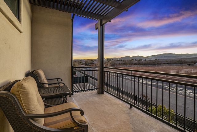 Master balcony seating with mountain view at sunset