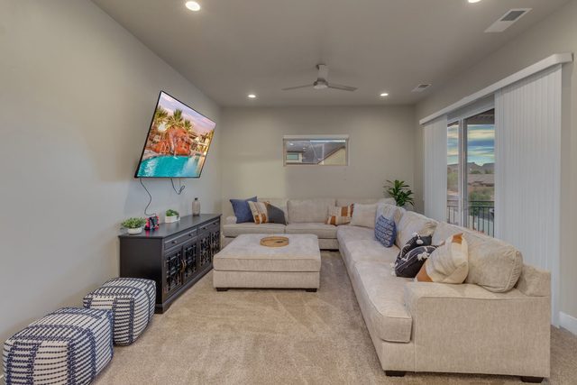 Upstairs loft with sectional sofa, ottoman and TV