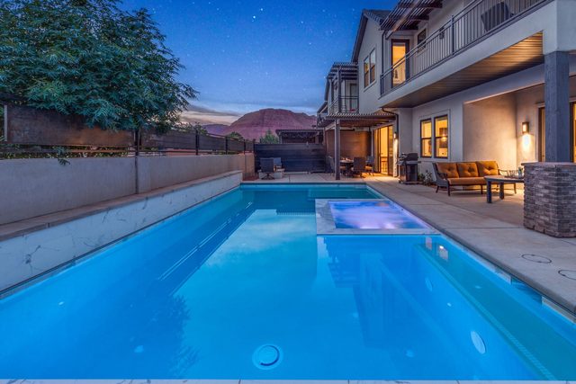 Private lap-style pool with attached spa and covered patio