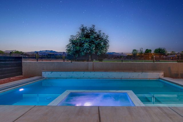 Private pool and spa at twilight with desert view