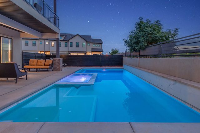 Lit private pool and spa beside the covered patio
