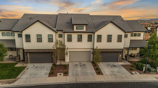 Row of Ocotillo Springs townhomes with garages at sunset