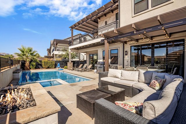 Backyard fire pit sectional beside the private pool