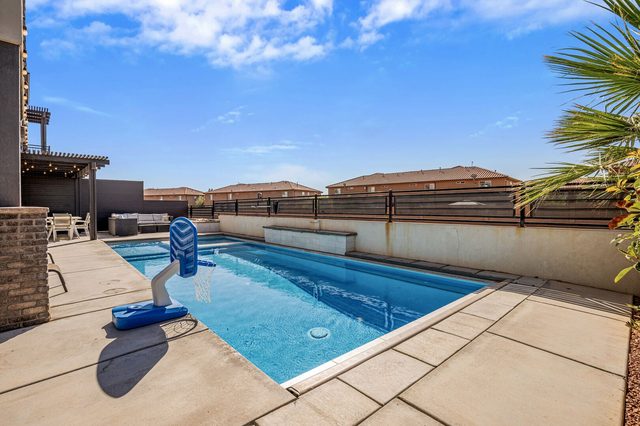Private pool with basketball hoop and lounge chairs