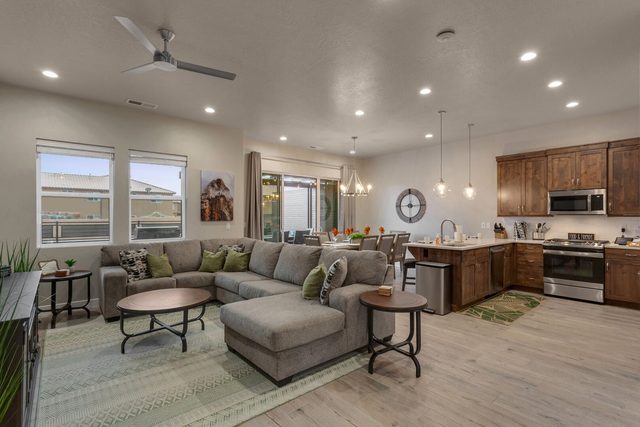 Open living room with sectional sofa flowing into the kitchen