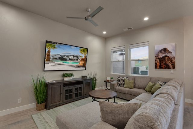 Living room sectional sofa facing a large wall-mounted TV