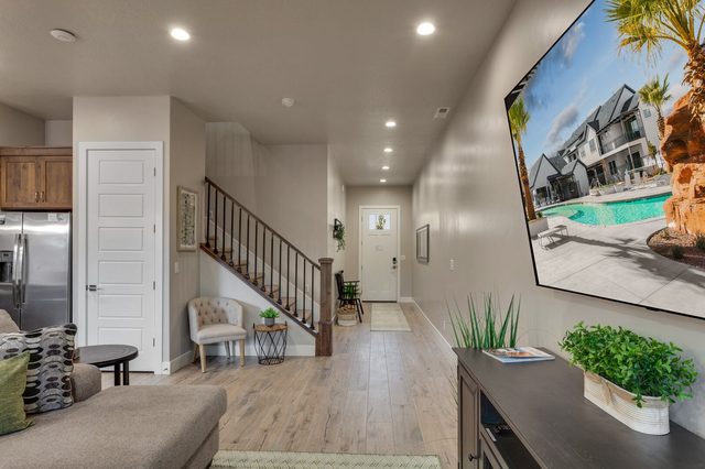 Living area looking toward the staircase and front entry