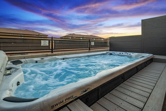 Private swim spa jets running in the fenced backyard