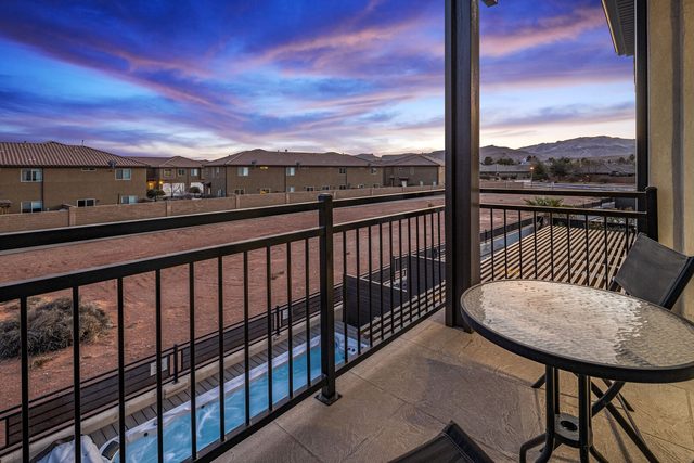 Master balcony view over the swim spa to desert hills at sunset