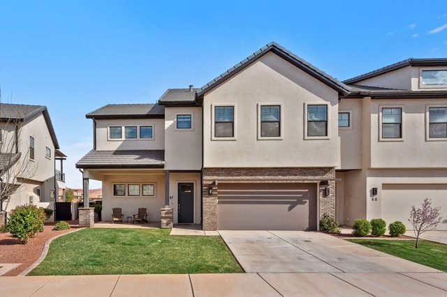 Front exterior of Ocotillo Springs 67 with two-car garage and lawn