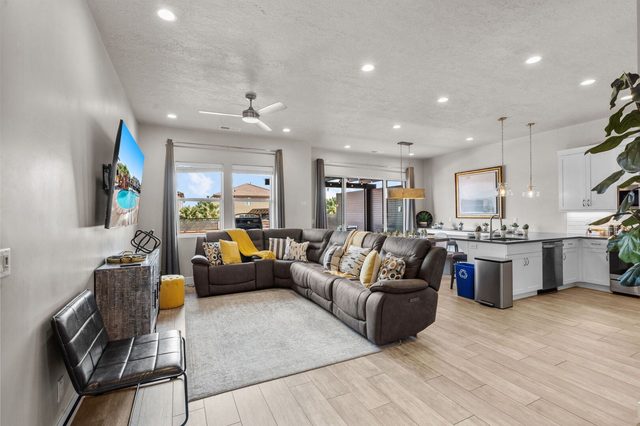 Open living room with sectional flowing into the kitchen