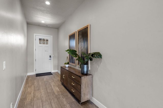 Front entry hallway with console table and artwork