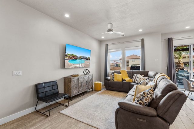 Living room with reclining sectional and wall-mounted TV