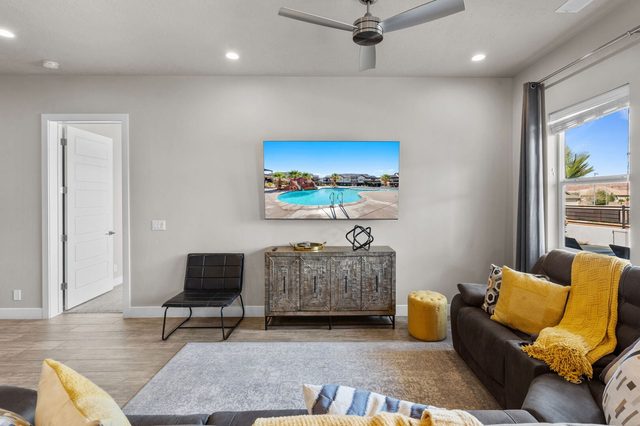 Living room sectional with yellow accents and large TV