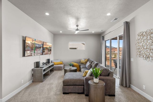 Upstairs lounge with large sectional near balcony doors