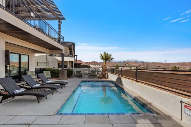 Private pool lined with lounge chairs at Ocotillo Springs 67