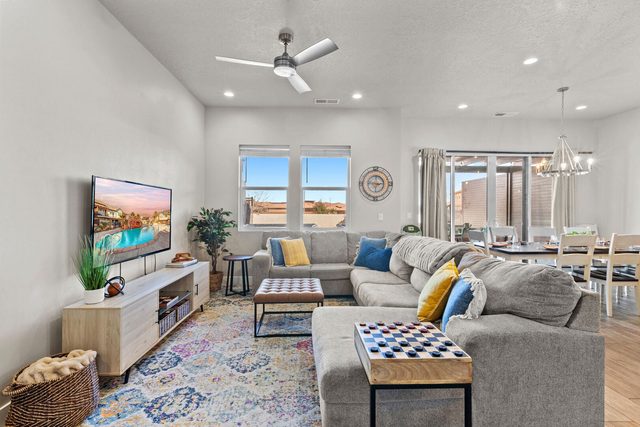 Living room sectional sofa, wall-mounted TV and checkerboard ottoman