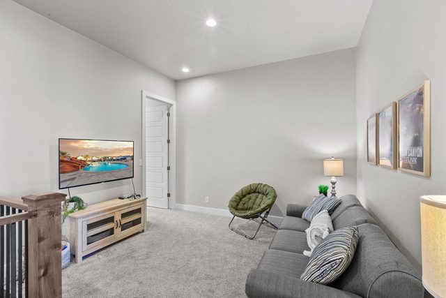 Upstairs loft TV area with sofa and stair railing
