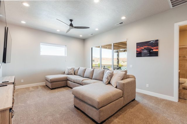 Upstairs loft with large sectional sofa and balcony doors