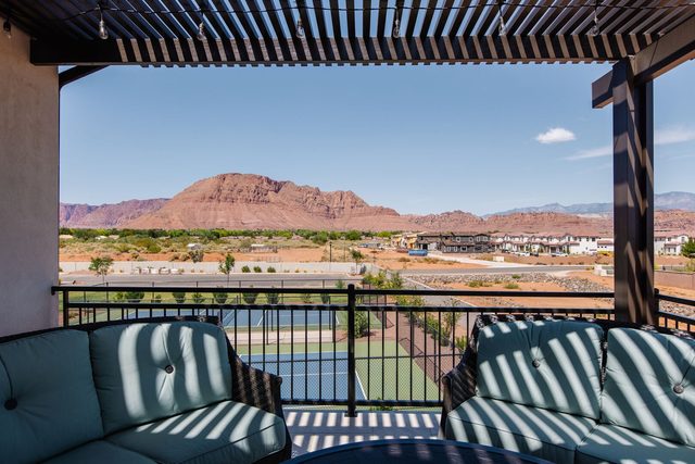 Balcony view of red rock mountain and community courts