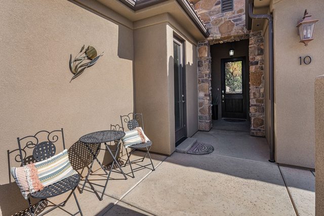Front courtyard entry with bistro seating at Paradise Village 10