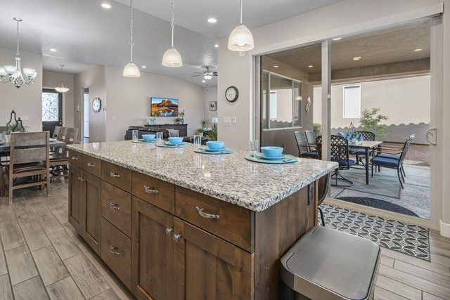 Granite kitchen island beside sliding doors to the patio at Paradise Village 10