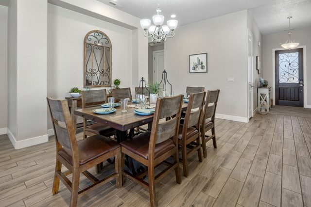 Wood dining table with chandelier near the front door at Paradise Village 10