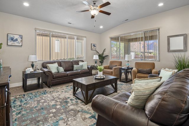 Living room with leather sofas and patterned rug at Paradise Village 10