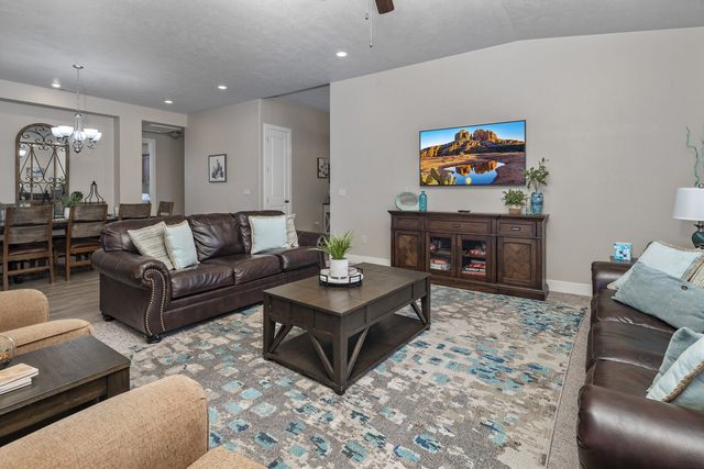 Living room with smart TV and dining table beyond at Paradise Village 10