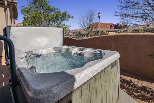 Private hot tub with red rock cliffs beyond at Paradise Village 10
