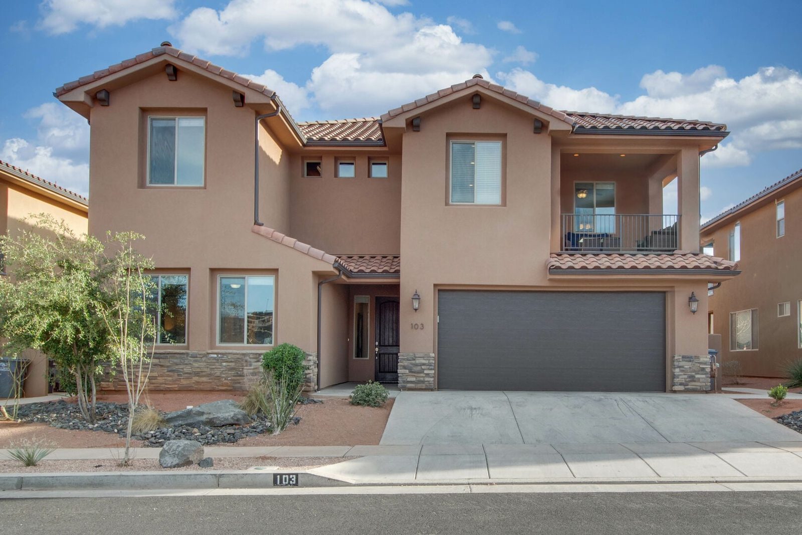 Two-story front exterior of Paradise Village 103 with two-car garage