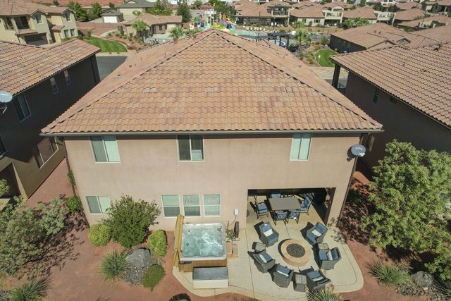 Aerial of the home's backyard with hot tub and fire pit
