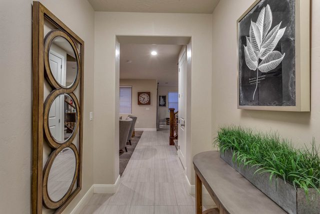 Entry hallway with round mirror and console table
