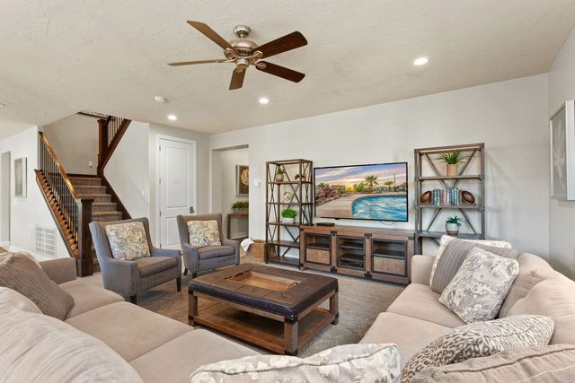 Living room with large sectional, armchairs and smart TV