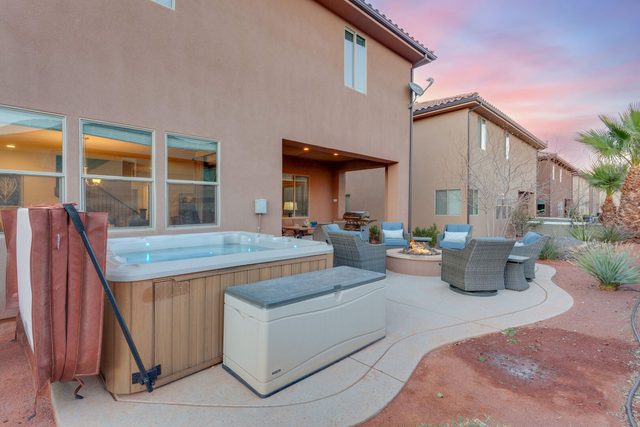 Private hot tub with storage bench and patio seating