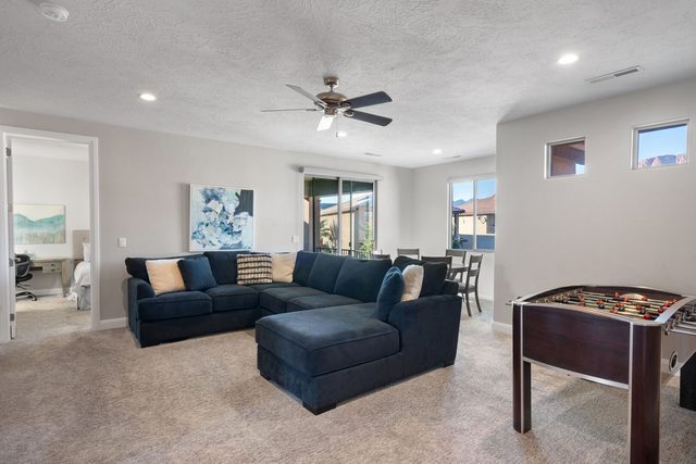 Upstairs loft with blue sectional sofa and foosball table