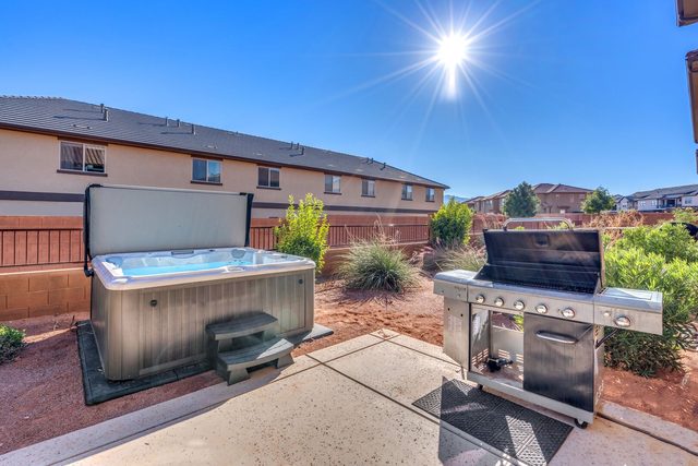 Private hot tub and BBQ grill in the fenced backyard