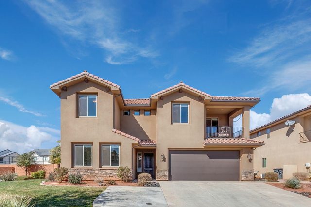 Front of the two-story home with balcony and two-car garage
