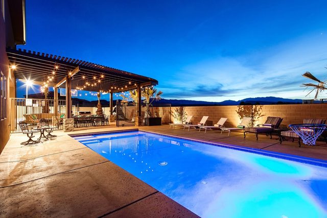Private pool at dusk beside the lit pergola patio at Paradise Village 107