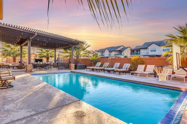 Private pool with lounge chairs and pergola at sunset at Paradise Village 107