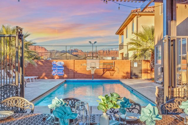 Private pool seen from the patio dining table with basketball hoop