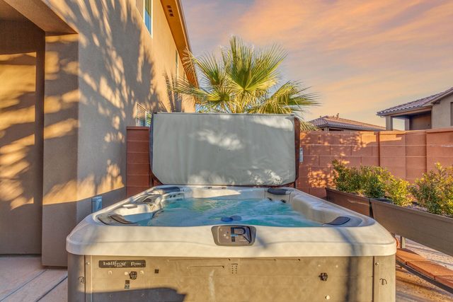 Private hot tub beside the home with palm trees behind